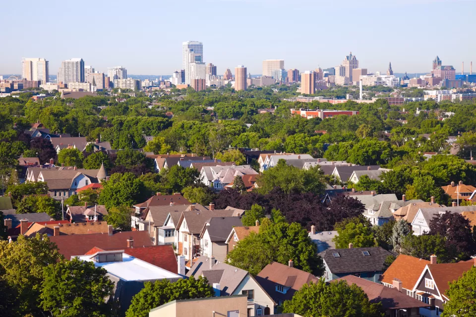 Milwaukee, Wisconsin skyline with houses in foreground.